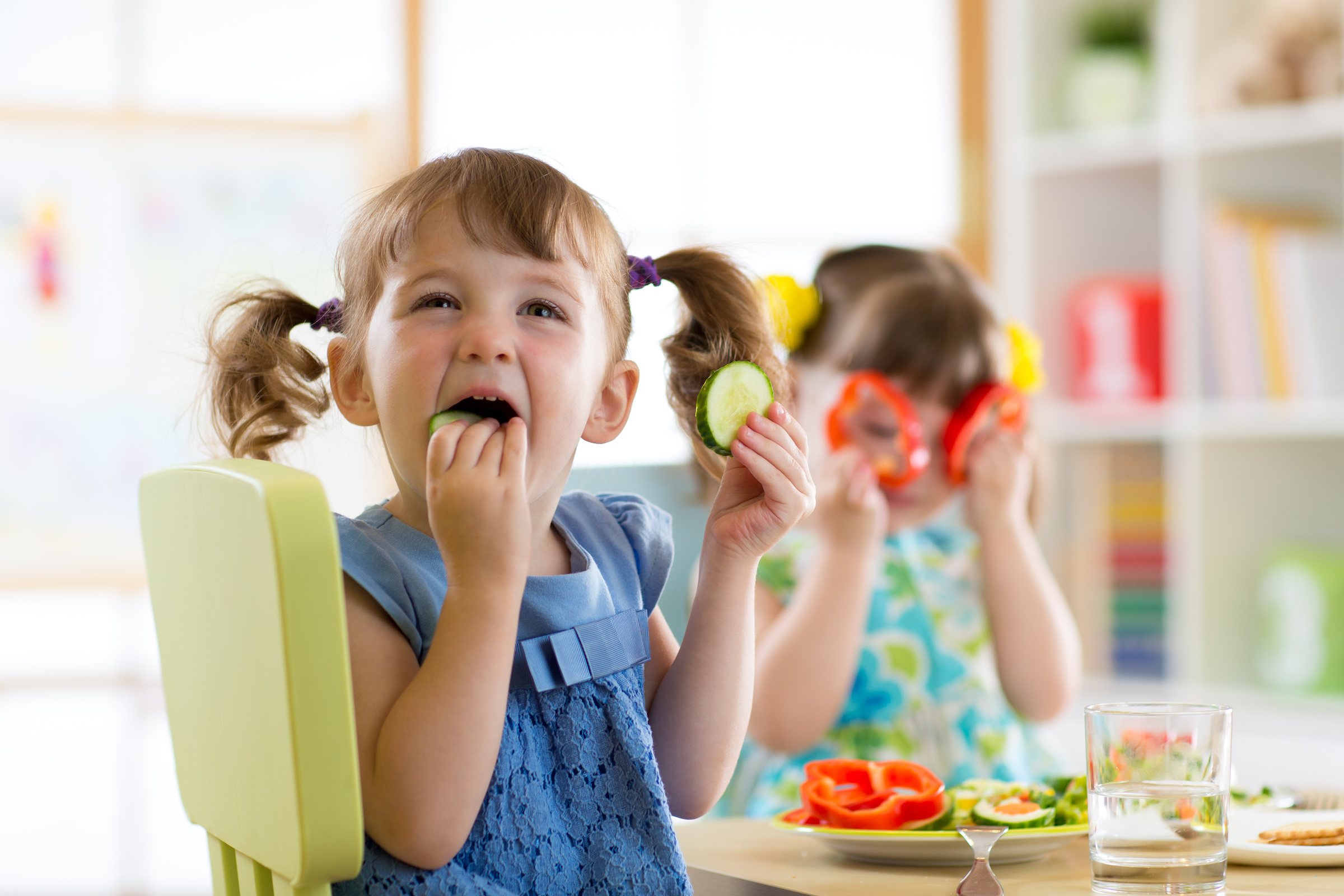 Children enjoying fresh vegetables at the lunch table