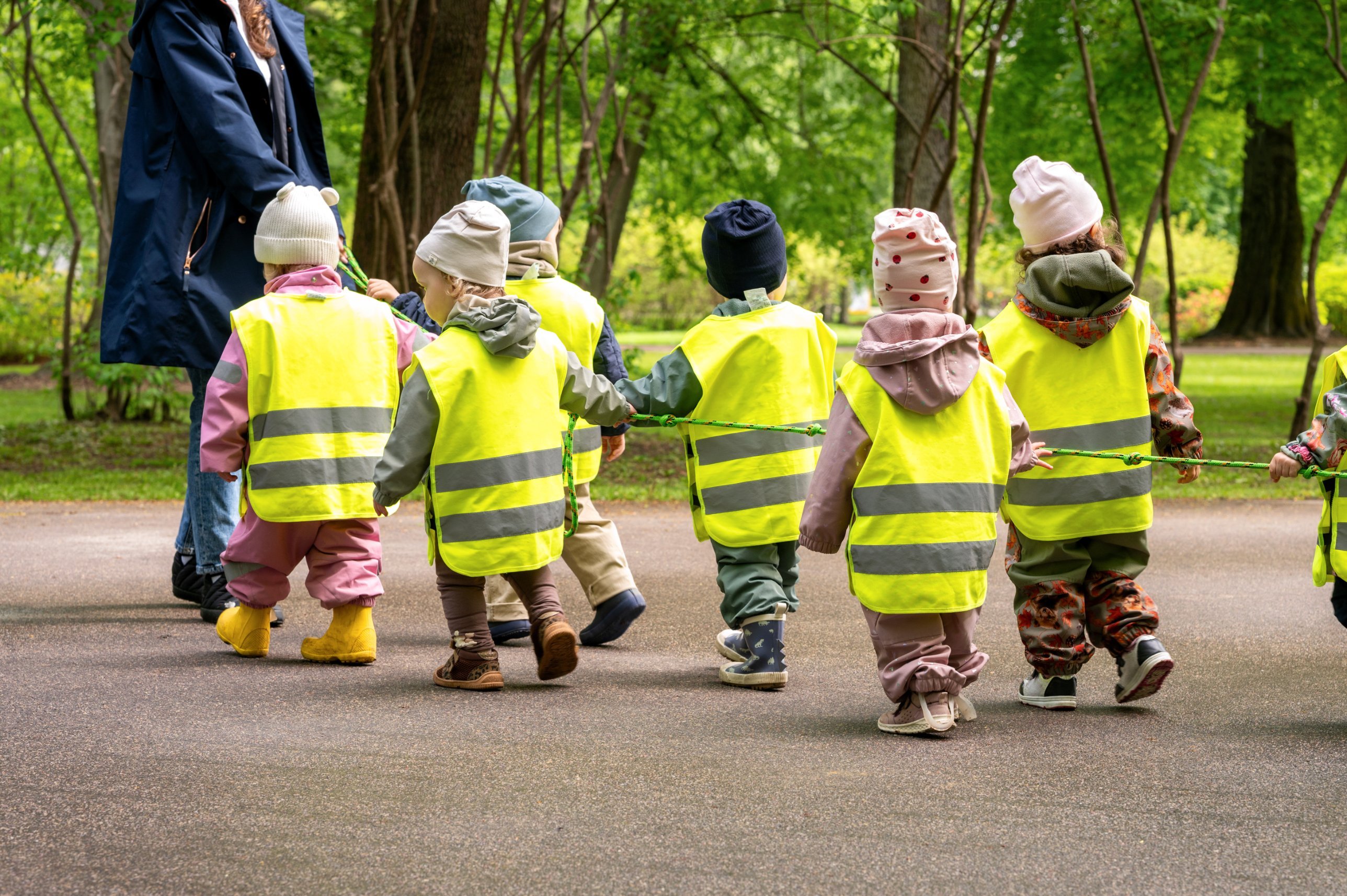 Toddlers on a neighbourhood walk with their educator