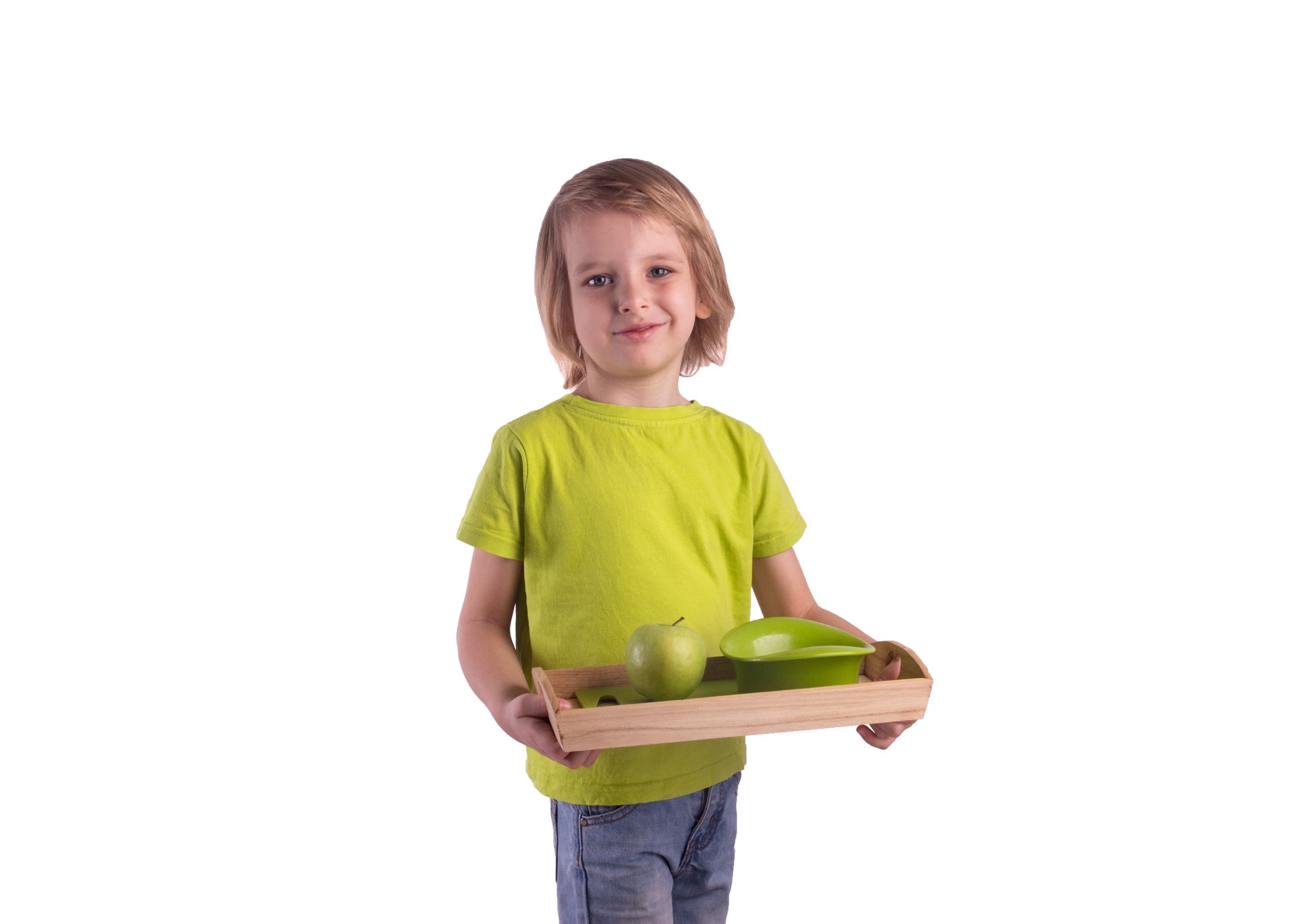 Child carrying a Montessori tray with an apple