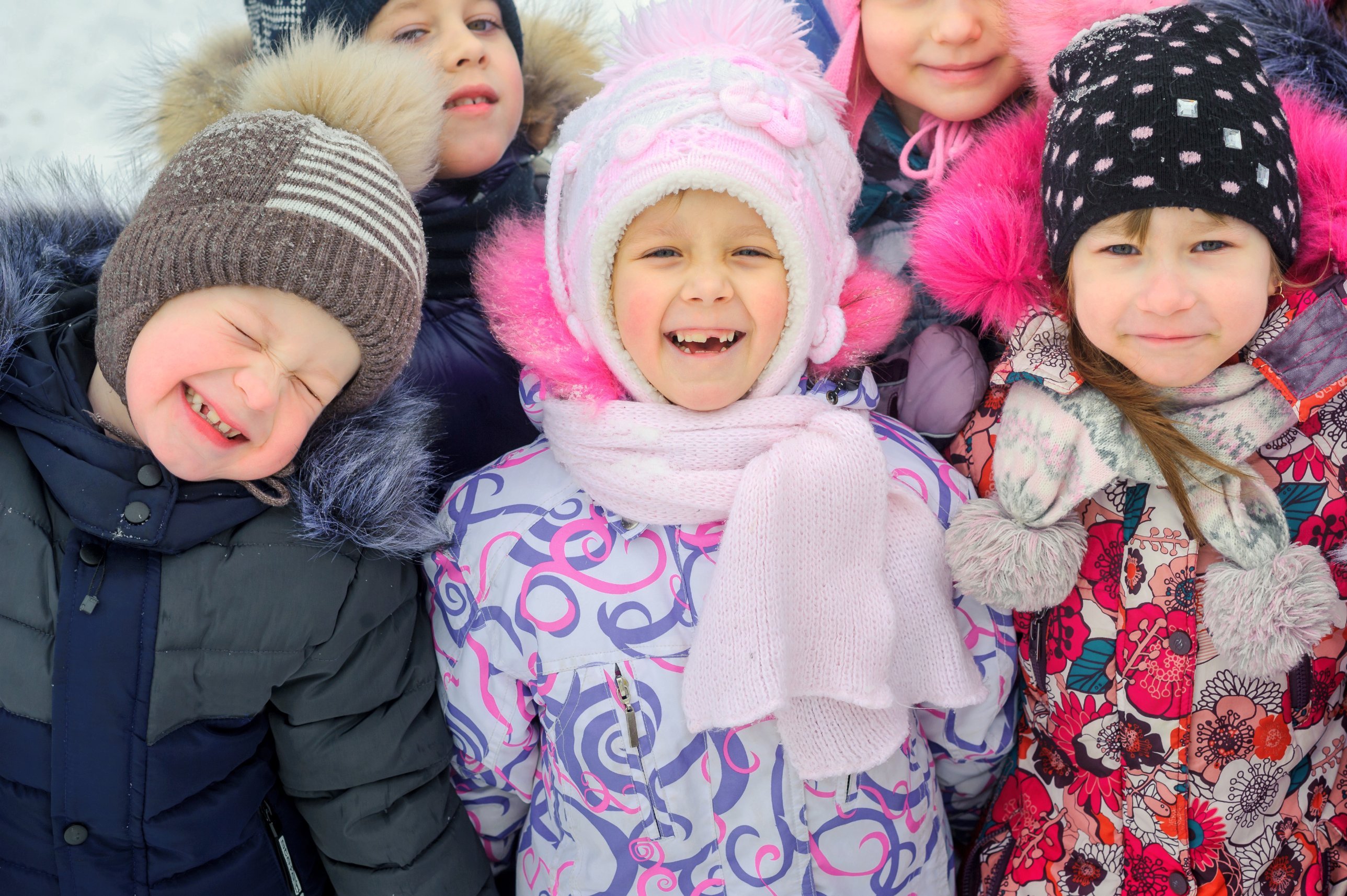 Happy children bundled up for outdoor play in winter